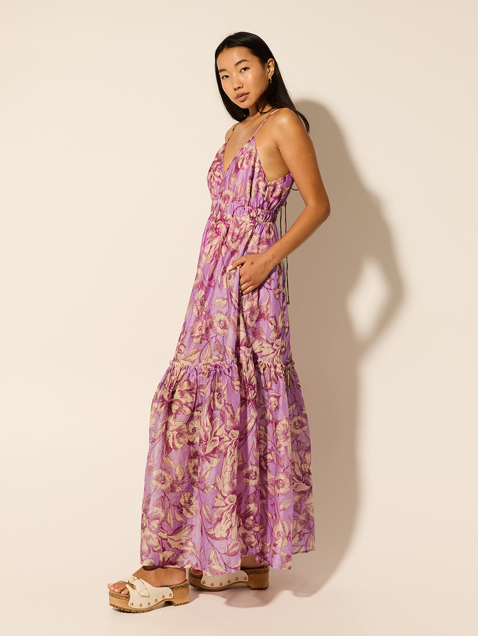 Reyna Maxi Dress KIVARI | Model wears purple floral maxi dress side view