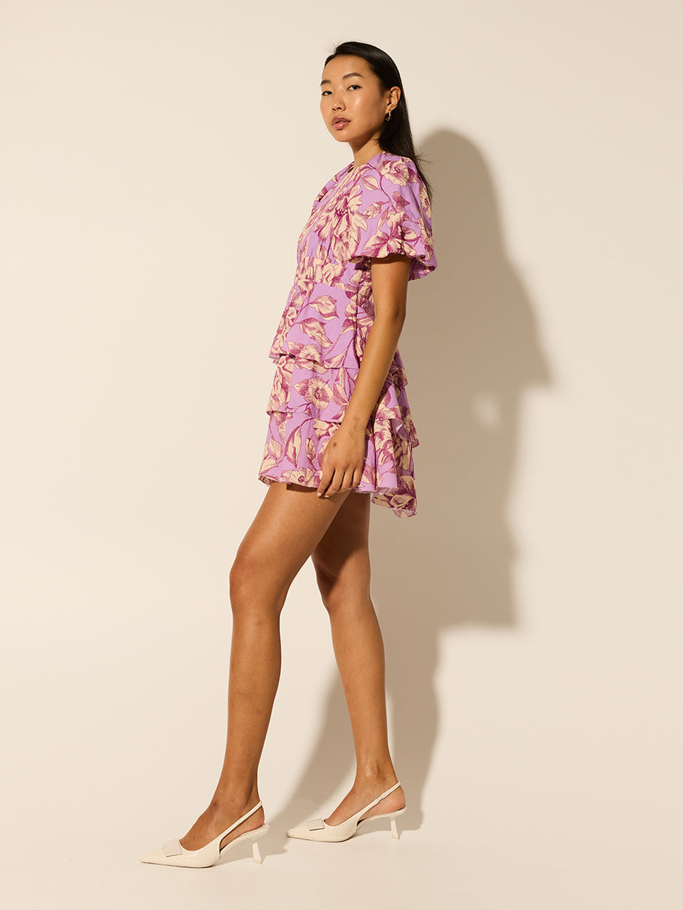 Reyna Mini Dress KIVARI | Model wears purple floral mini dress side view