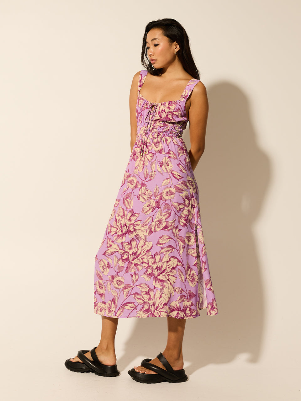 Reyna Strappy Midi Dress KIVARI | Model wears purple floral strappy midi dress side view