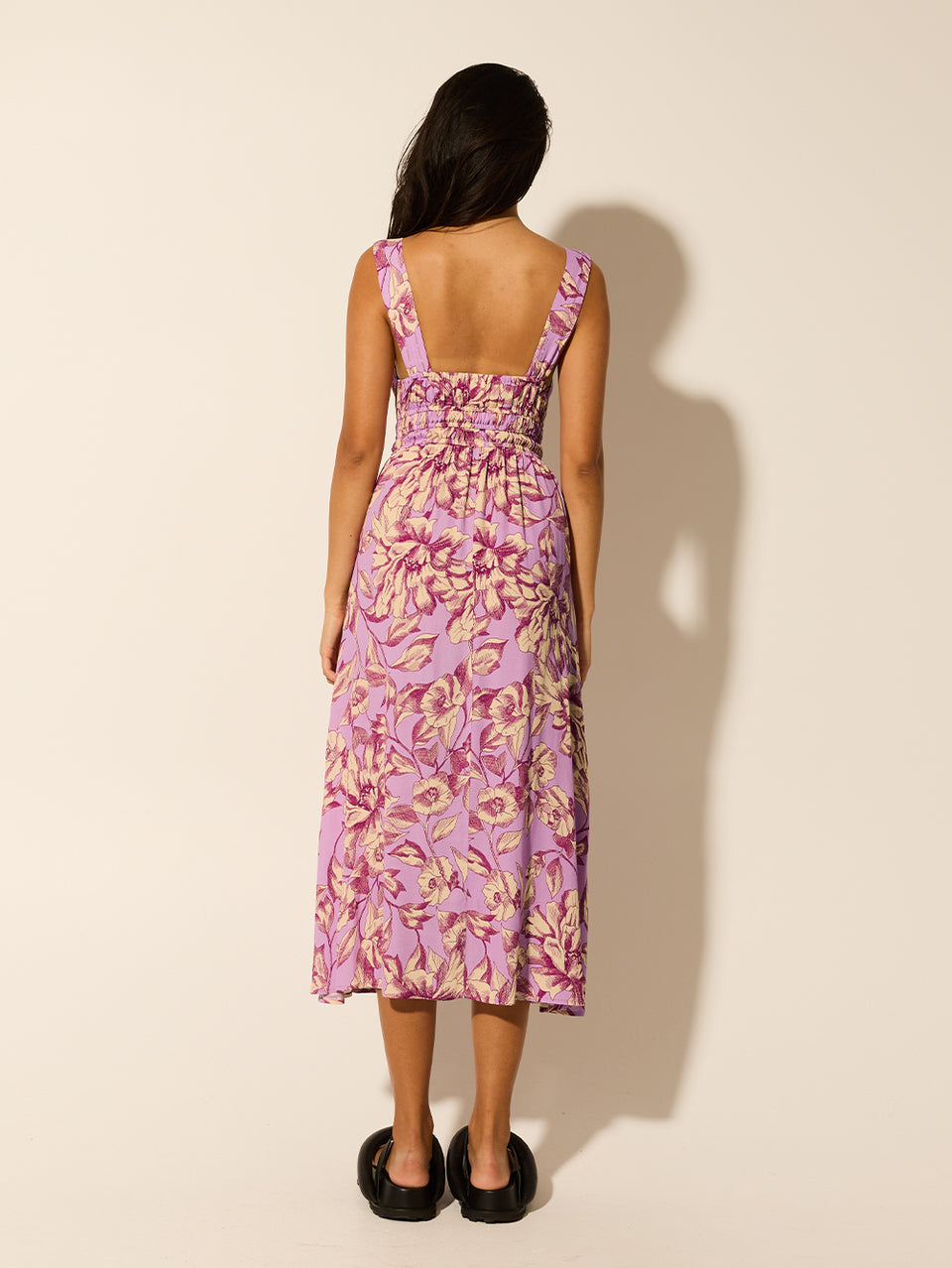 Reyna Strappy Midi Dress KIVARI | Model wears purple floral strappy midi dress back view