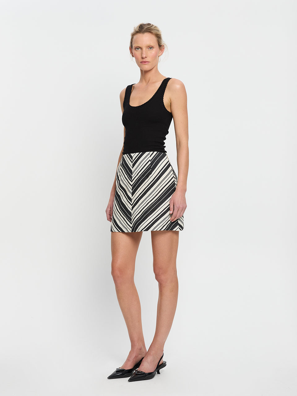 Sara Mini Skirt KIVARI | Model wears stripe linen skirt side view