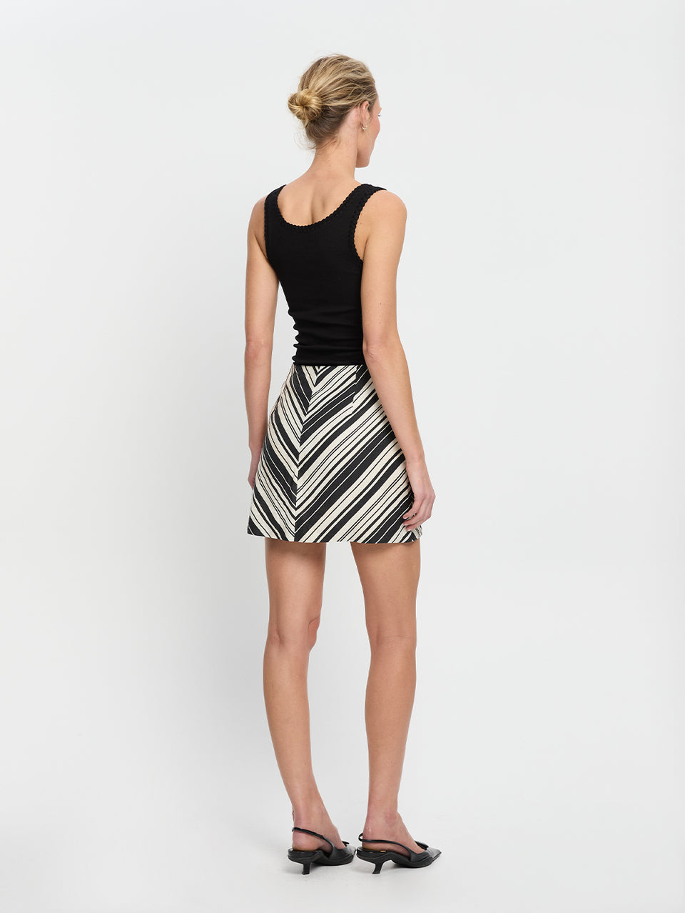 Sara Mini Skirt KIVARI | Model wears stripe linen skirt back view