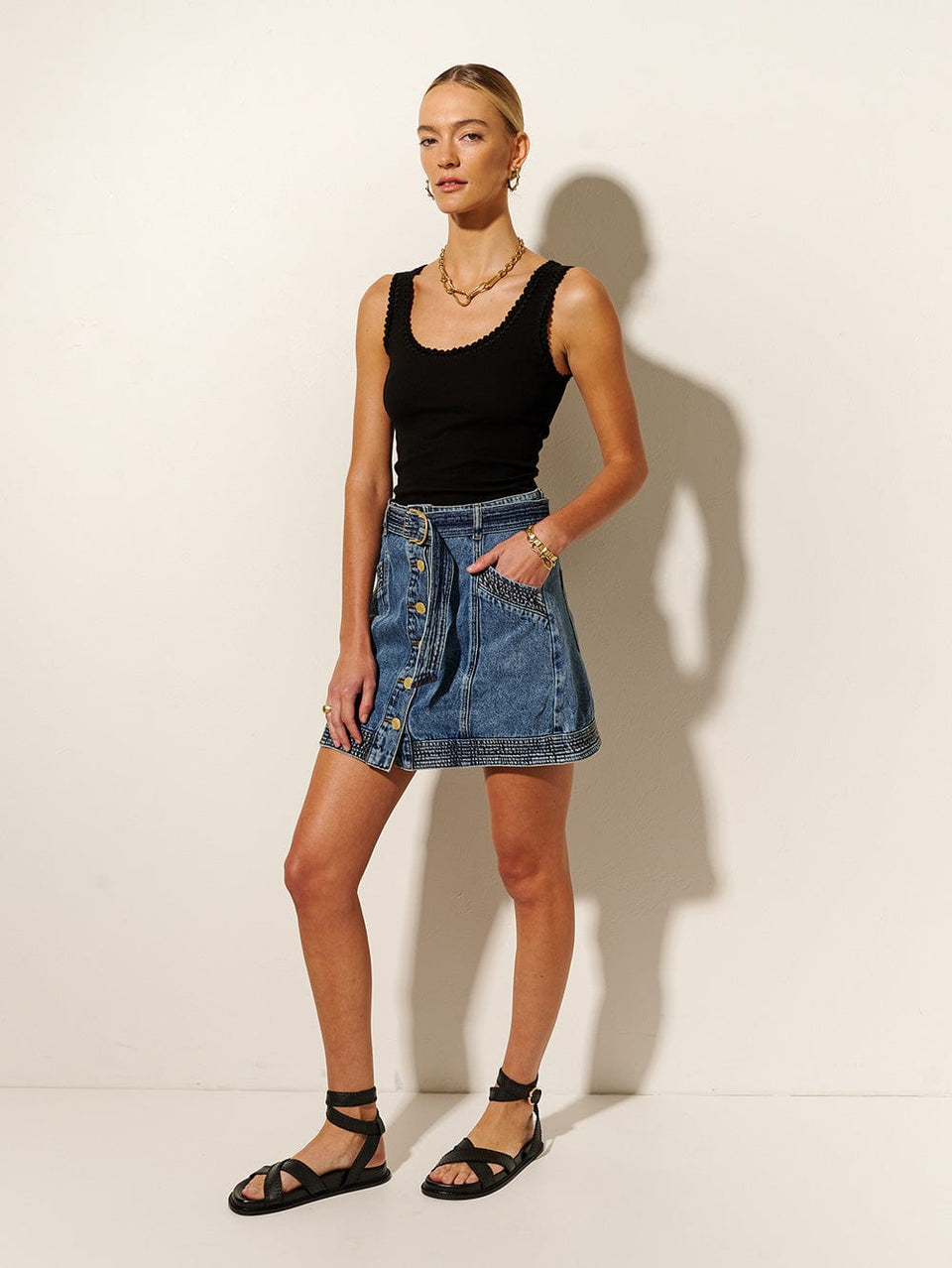 Tahlia Denim Skirt KIVARI | Model wears blue denim skirt side view