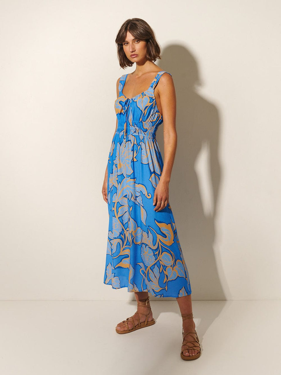 Taniana Midi Dress KIVARI | Model wears blue and orange floral midi dress side view