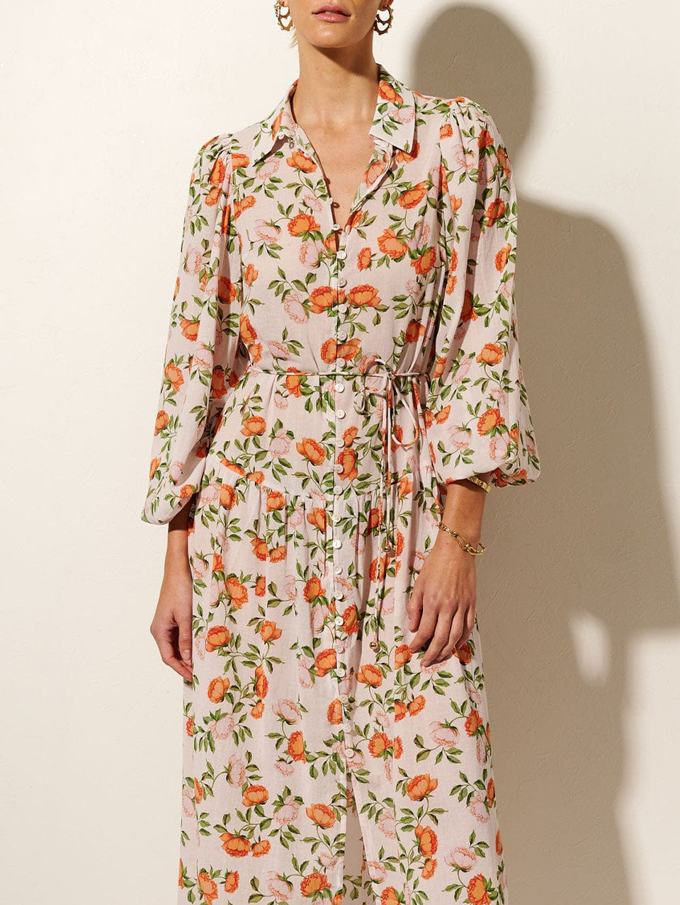 KIVARI Verenna Babydoll Midi Dress | Model wears Orange and Green Floral Midi Dress