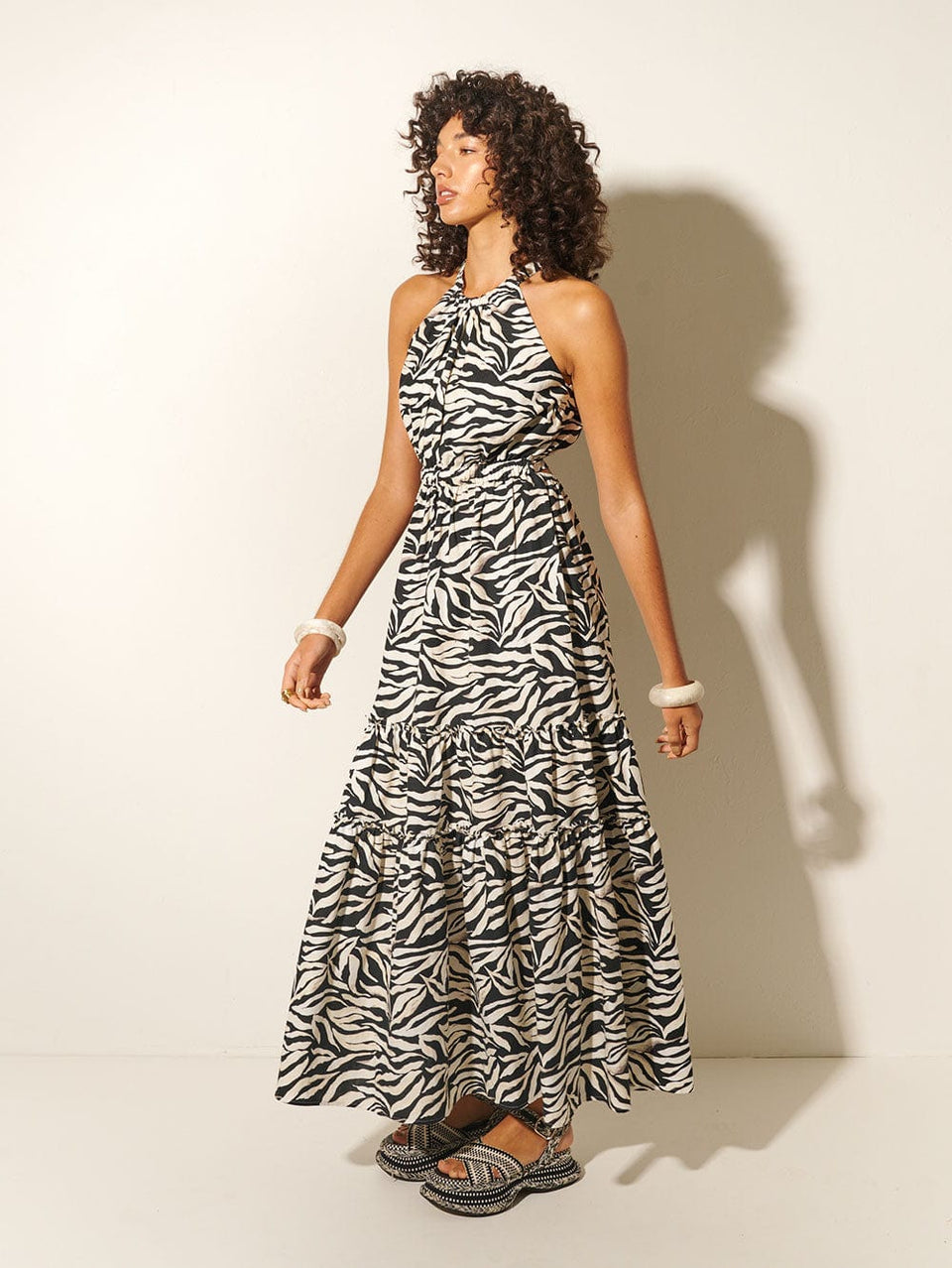 Zenya Halter Maxi Dress KIVARI | Model wears zebra printed halterneck maxi dress side view