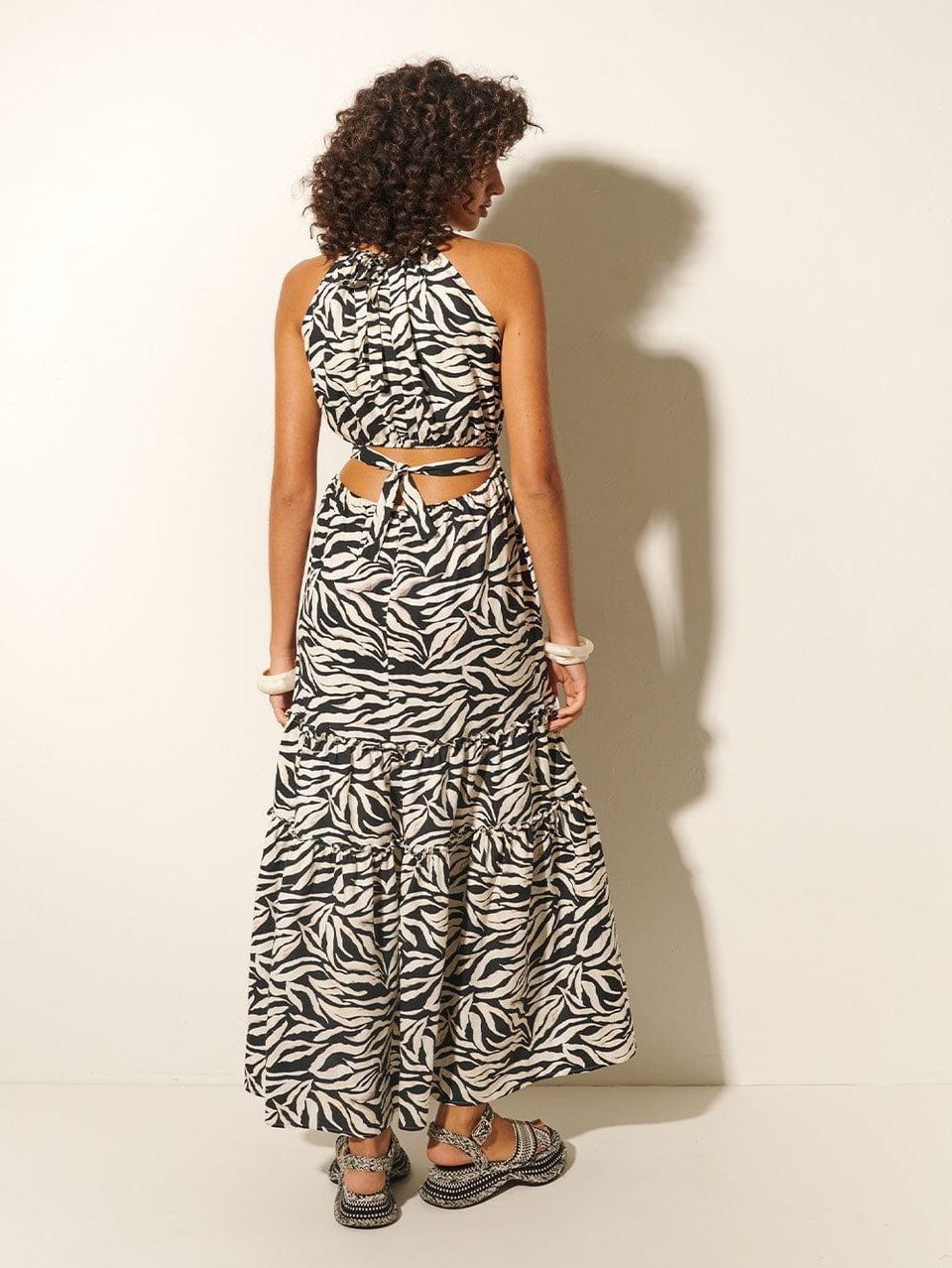 Zenya Halter Maxi Dress KIVARI | Model wears zebra printed halterneck maxi dress back view