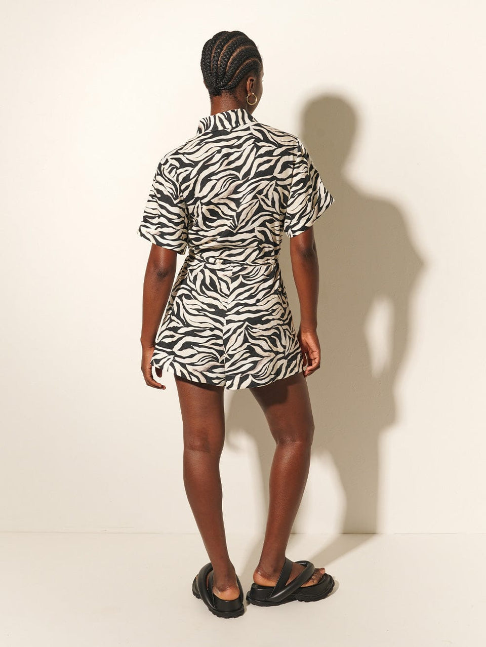 Zenya Playsuit KIVARI | Model wears zebra printed playsuit back view